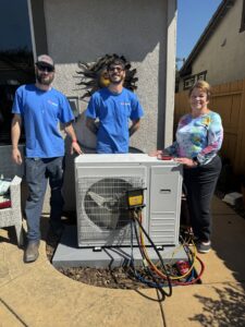 Airmech Heating and Air Conditioning technicians with a happy customer after a new mini-split installation in Elk Grove, CA.