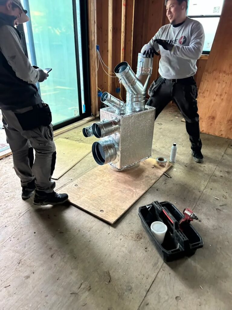 HVAC technicians from Fuse HVAC & Appliance Repair Boston installing ductwork components in West Roxbury, MA.