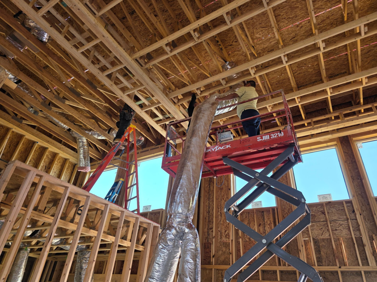 HVAC technicians installing ductwork in a new construction residential building for Lone Star Mechanical in El Paso, TX.