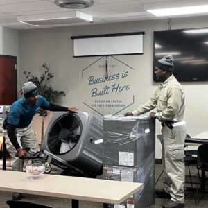 Two HVAC technicians installing new heating and cooling equipment for Relief Heating and Cooling, LLC in Greensboro, NC.