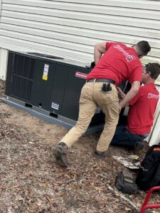 HVAC technicians from Tadlock Heating & Air Conditioning installing an outdoor unit in Tallahassee, FL