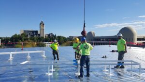 R&R Heating & Air Conditioning technicians installing metal frames for rooftop HVAC units in Spokane, WA.