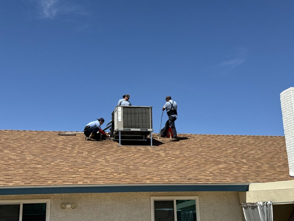 HVAC technicians installing a rooftop unit for Rebel Refrigeration in Las Vegas, NV.