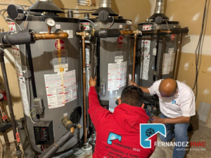 HVAC technicians from Fernandez HVAC installing multiple water heaters in Alexandria, VA.