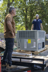 HVAC technicians from Infinite Comfort preparing a new HVAC unit for installation in Youngsville, NC.