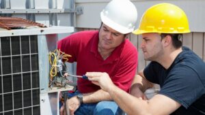 HVAC technicians from Expert Air Conditioning & Heating repairing an outdoor AC unit in Las Vegas, NV.