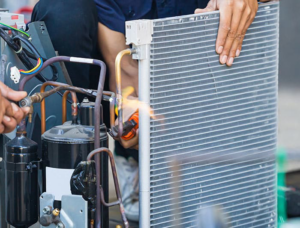 HVAC technicians repairing an air conditioning unit at Vassar's Service of Richmond in Richmond, VA