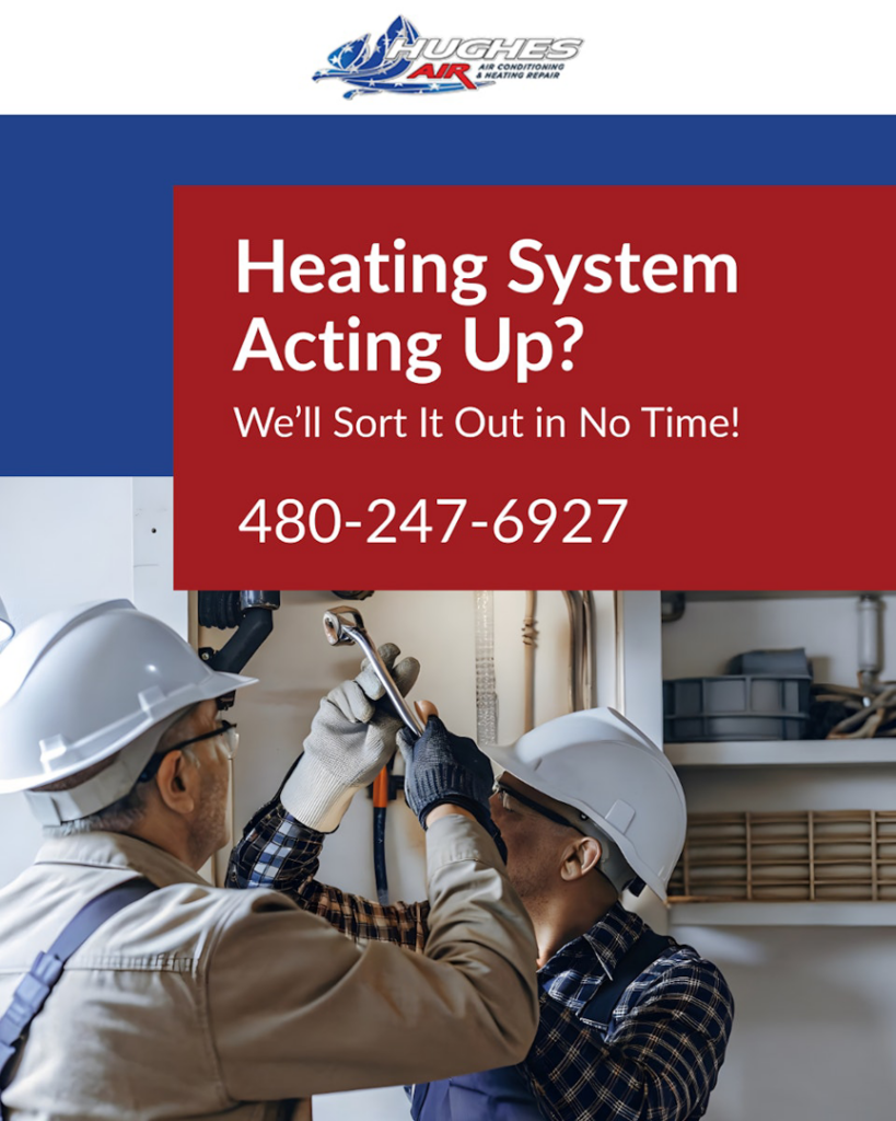 Two HVAC technicians from Hughes Air Heating & Cooling repairing a heating system in Mesa, AZ.