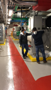 HVAC technicians servicing a large commercial chiller unit at HVAC MD GROUP in Laurel, MD.