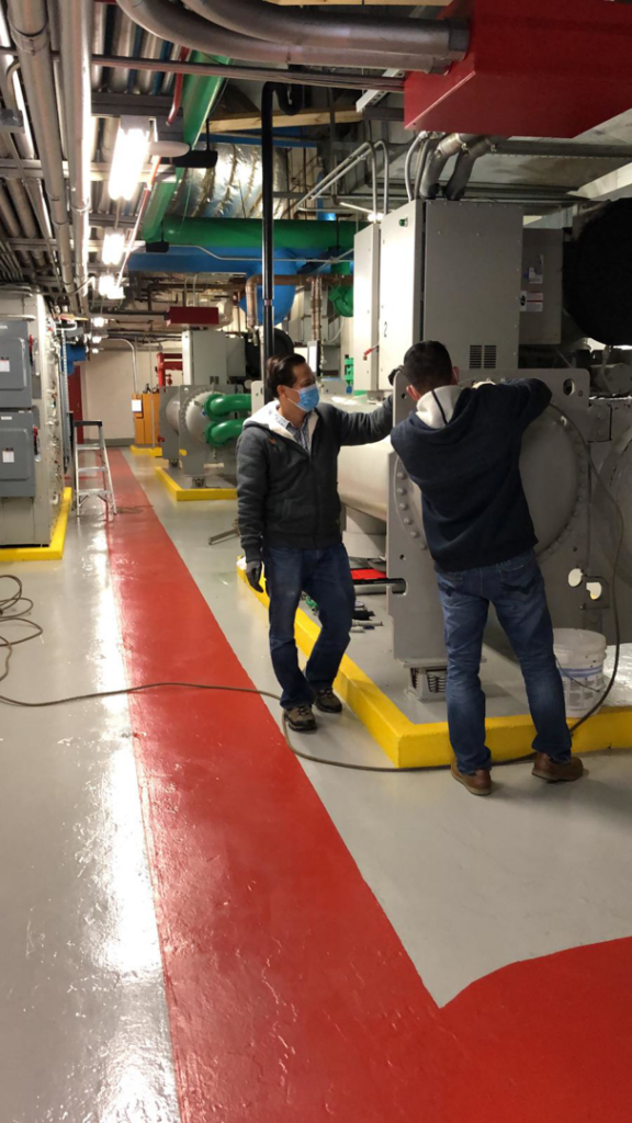 HVAC technicians servicing a large commercial chiller unit at HVAC MD GROUP in Laurel, MD.