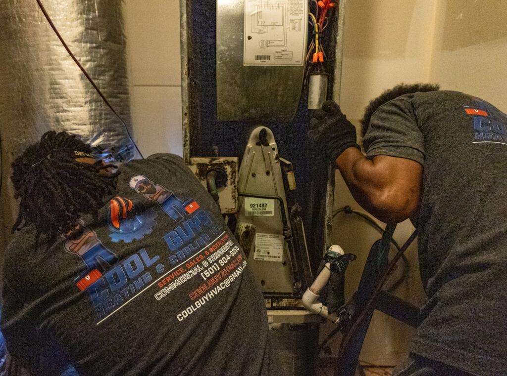 Cool Guys Heating & Air LLC technicians servicing an indoor furnace unit in North Little Rock, AR.
