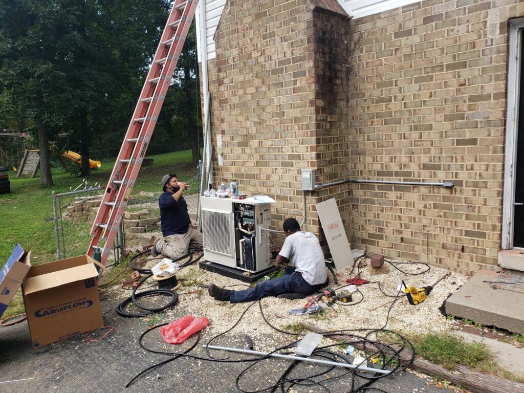 Two HVAC technicians servicing an outdoor unit next to a brick house for Air Energy Solutions in North Chesterfield, VA