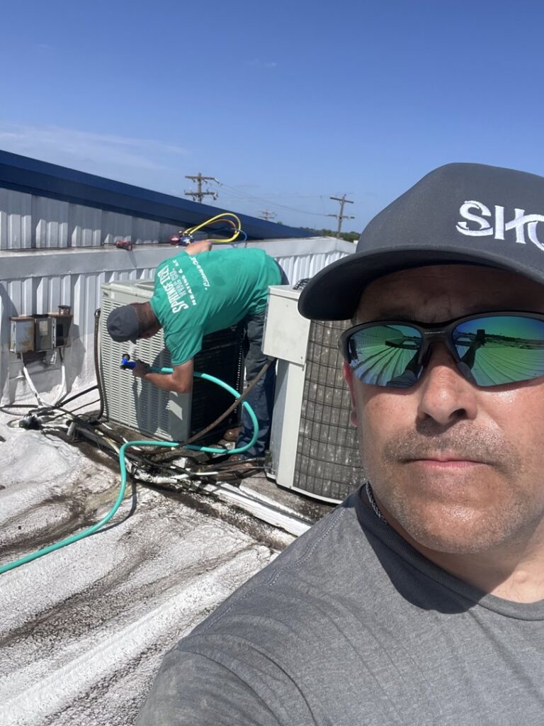 HVAC technicians from Springfield HVAC Company servicing a rooftop air conditioning unit in Springfield, MO.