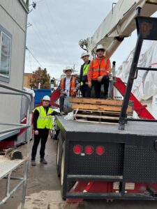 HVAC technicians with a crane truck preparing for equipment installation at a job site for Boise Valley Heating & Air in Meridian, ID
