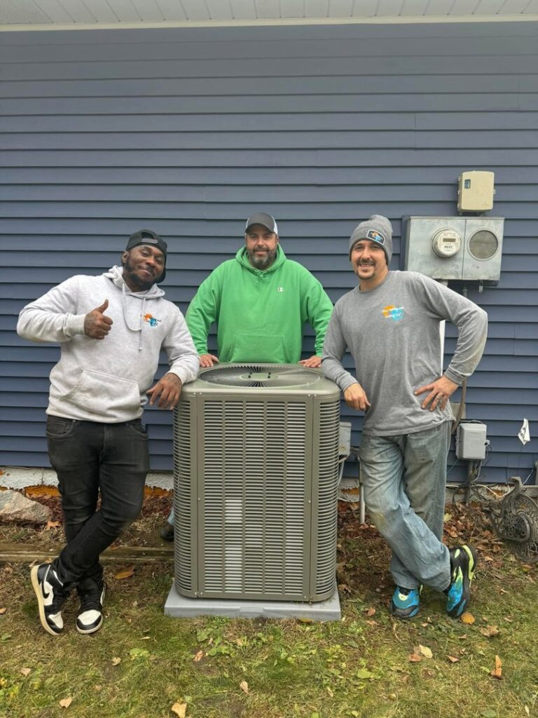 Three HVAC technicians posing with a newly installed outdoor air conditioning unit by Cyber Heating and Cooling in Bloomington, MN.