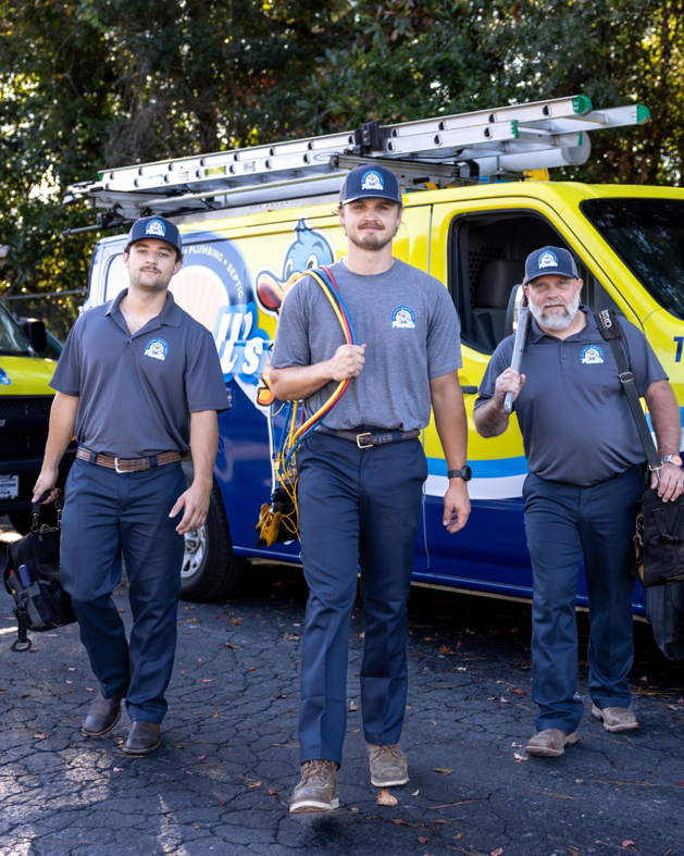 HVAC technicians with tools standing in front of a service van for Powell's of Wilmington, NC