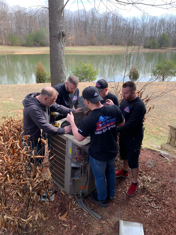HVAC technicians from Air Solutions Heating and Cooling, LLC. working on an outdoor condenser unit in Louisville, KY.