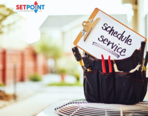 A tool bag and clipboard on an outdoor AC unit, ready for service by Setpoint Refrigeration LLC in Liberty Hill, TX