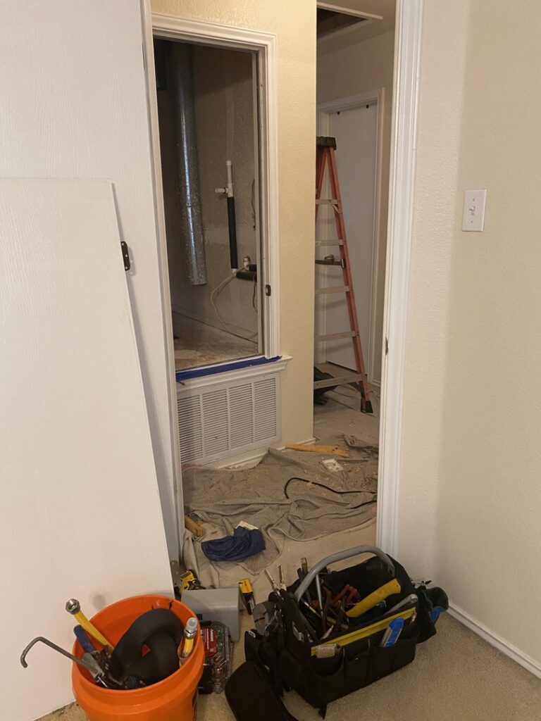 HVAC tools and equipment in a hallway with visible ductwork, indicating work by Goettl Austin in Austin, TX