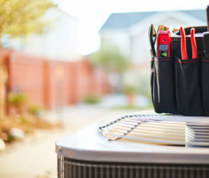 HVAC tools resting on an outdoor air conditioning unit, ready for service by Morse Brothers Heating and Air in Franklin, TN.