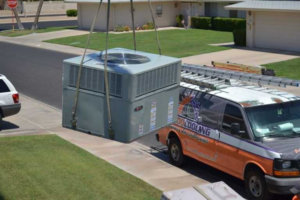 A large HVAC unit being lifted by a crane for installation or replacement by 1 800 Cooling, INC in Phoenix, AZ.
