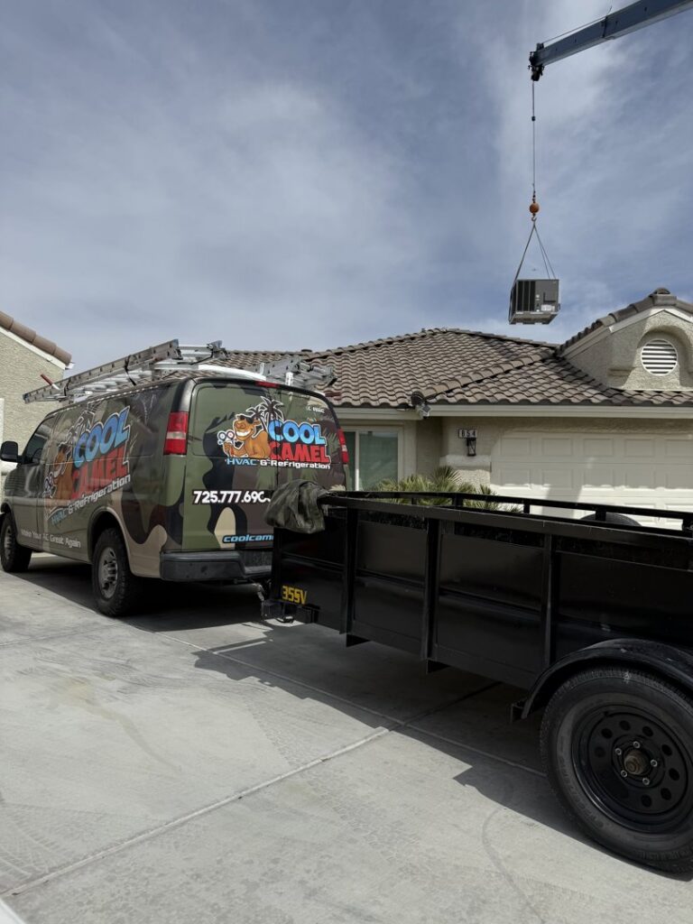 An HVAC unit being lifted by a crane over a residential house for installation by Cool Camel HVAC in Henderson, NV