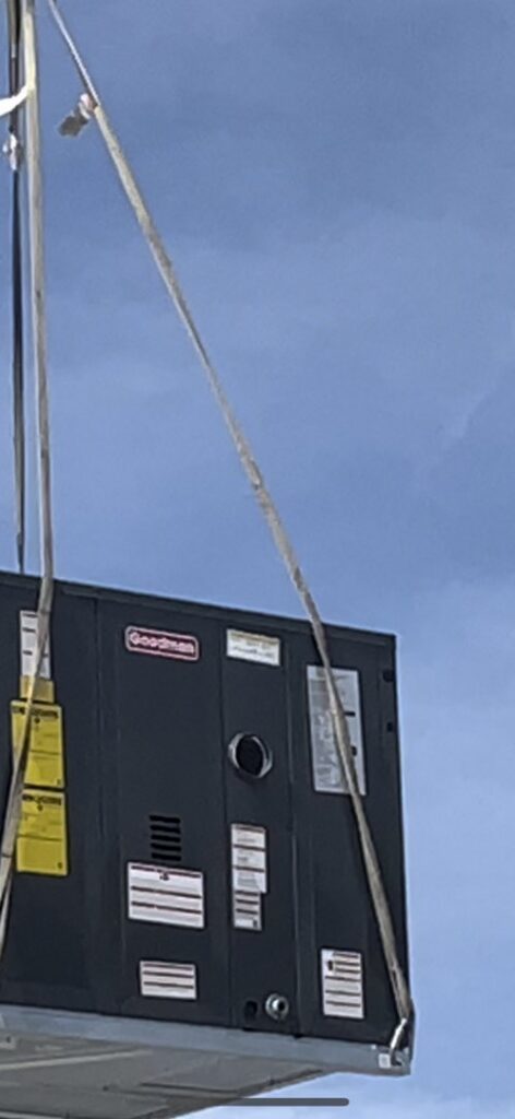 A new HVAC unit being carefully lifted by straps for installation by Usa Air Conditioning & Heating in Las Vegas, NV