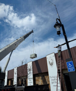 An HVAC unit being lifted by a crane for installation by Tornado Heating and Air in Tulsa, OK.