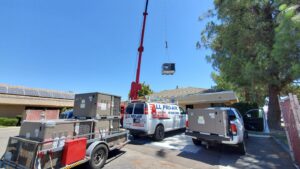 New HVAC units being delivered by crane and service van for All Pro Air in Warrenville, IL.