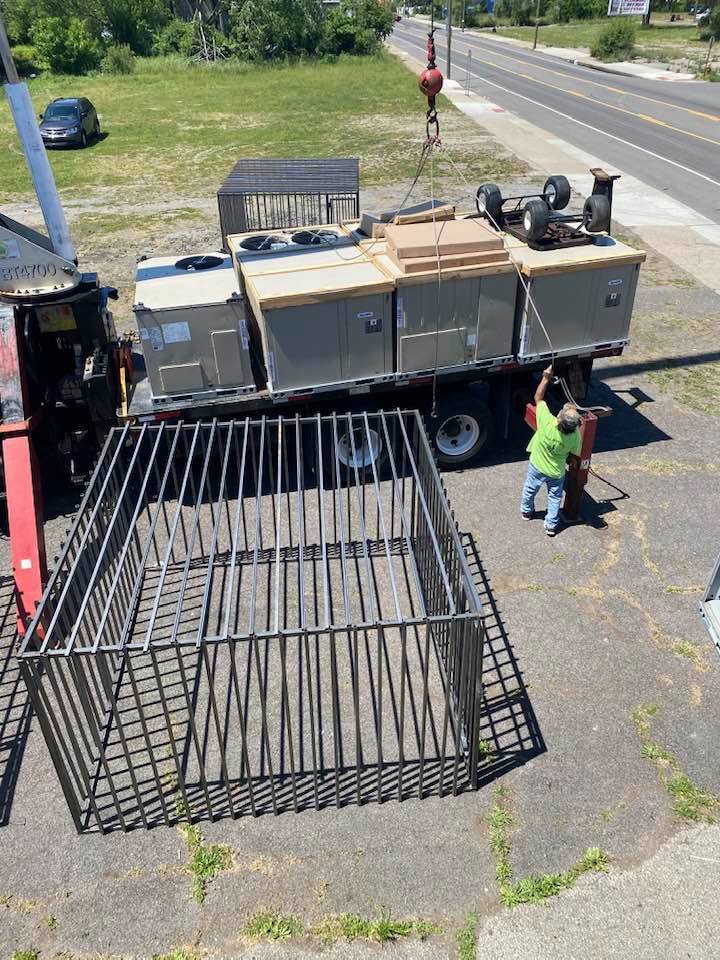 A crane lifting new HVAC units for delivery by Good Helpers Heating, Cooling & Labor Services LLC in Detroit, MI.