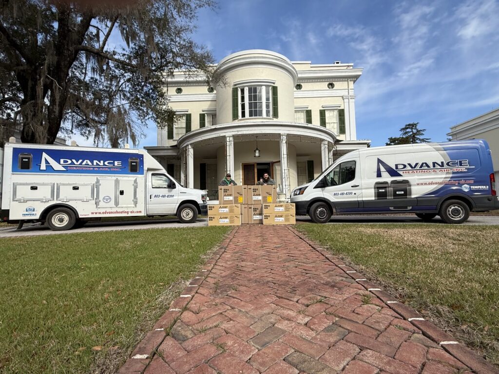 Advance Heating & Air, Inc. technicians delivering new HVAC units for installation at a large home in Sumter, SC.