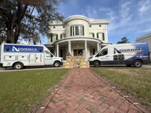 Advance Heating & Air, Inc. technicians delivering new HVAC units for installation at a large home in Sumter, SC.