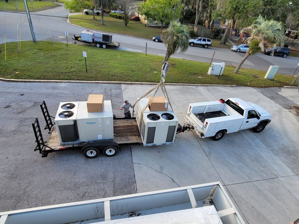Large Daikin HVAC units being delivered and prepared for installation by Huggins Mechanical in Jacksonville, FL