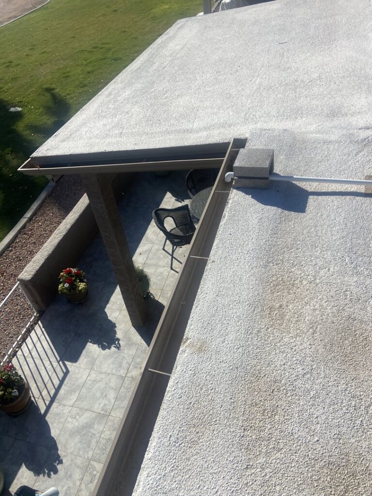 A close-up of an HVAC unit's drain pipe on a rooftop, serviced by Schiller Heating & Cooling in Tempe, AZ.