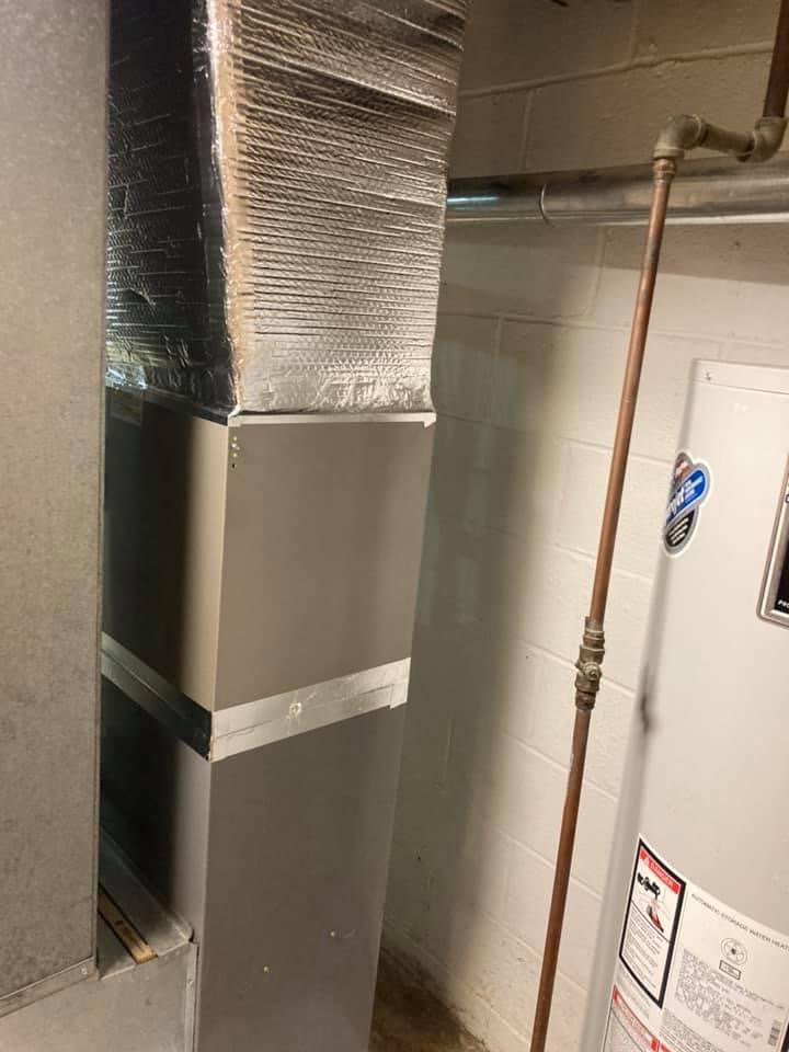 A new HVAC unit and ductwork installed in a basement by Manny Services in Syracuse, NY.