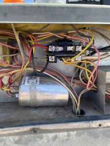Close-up of electrical wiring and components inside an HVAC unit being serviced by Sun Devil Heating & Cooling INC in Peoria, AZ.