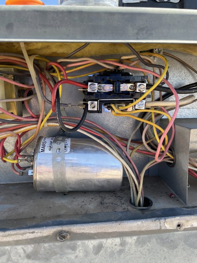 Close-up of electrical wiring and components inside an HVAC unit being serviced by Sun Devil Heating & Cooling INC in Peoria, AZ.