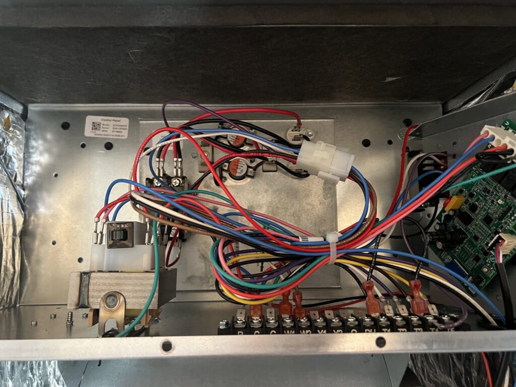 A close-up view of the electrical wiring and control board inside an HVAC unit serviced by Fields Cooling Heating & Refrigeration in Foley, AL.