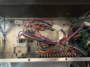 A close-up view of the electrical wiring and control board inside an HVAC unit serviced by Fields Cooling Heating & Refrigeration in Foley, AL.