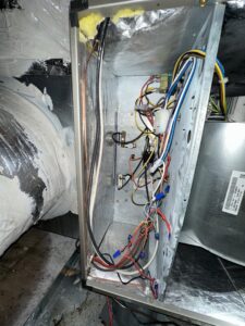 An open HVAC unit revealing complex electrical wiring and components, serviced by Love HVAC LLC in Bluffton, SC.