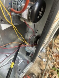 Close-up of electrical wiring and components inside an HVAC unit being serviced by McNeal and Sons Electrical and HVAC in Birmingham, AL.