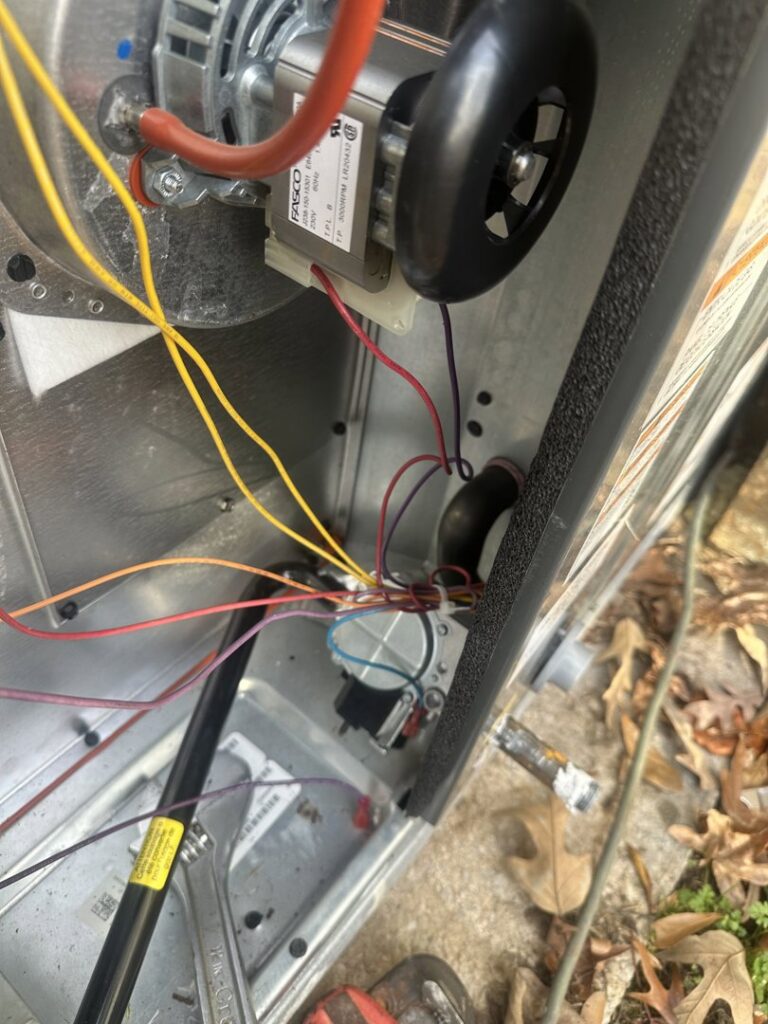 Close-up of electrical wiring and components inside an HVAC unit being serviced by McNeal and Sons Electrical and HVAC in Birmingham, AL.