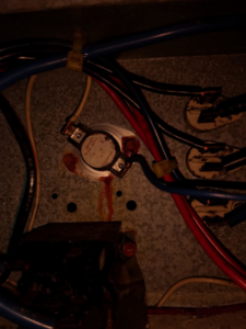 Close-up of electrical wiring and components inside an HVAC unit during a repair by Pettry Plumbing Heating & Air Inc in Bentonville, AR