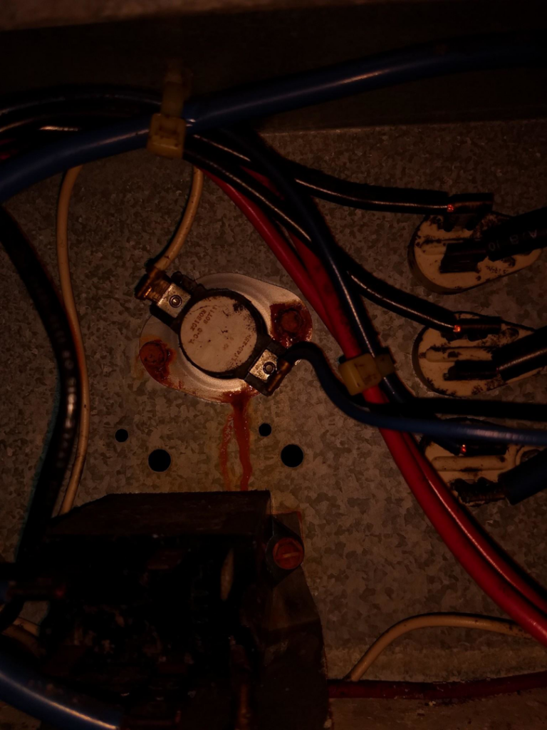 Close-up of electrical wiring and components inside an HVAC unit during a repair by Pettry Plumbing Heating & Air Inc in Bentonville, AR