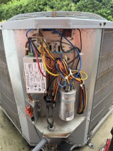 Close-up of electrical wiring inside an outdoor HVAC unit being serviced by Tenax Electrical Company in Jacksonville, FL.