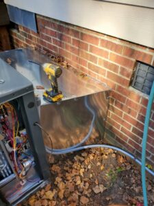 An open electrical panel on an HVAC unit showing wiring, indicating repair by Tim Lambert Electric in Fayetteville, NC.