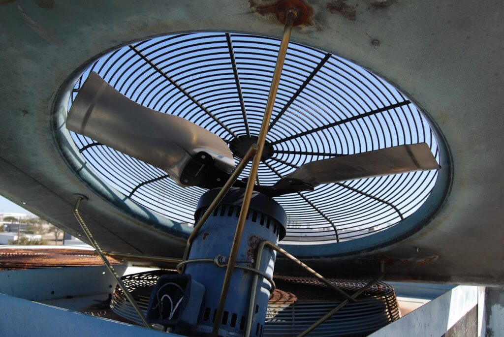 Close-up view of a large fan component inside an HVAC unit, inspected by Chapman Air and Heat in Dallas, TX
