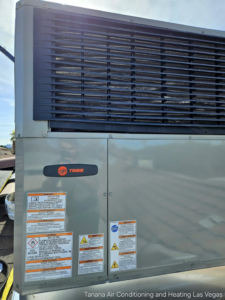 A close-up view of an outdoor Trane HVAC unit, likely undergoing inspection or maintenance by Tanana Air Conditioning & Heating in Las Vegas, NV.