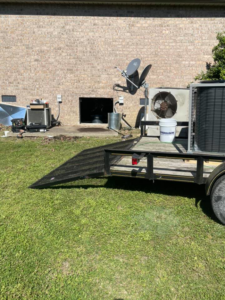 HVAC unit installation in progress with equipment on a trailer and a unit on the ground by Wright Air Care in Murfreesboro, TN.