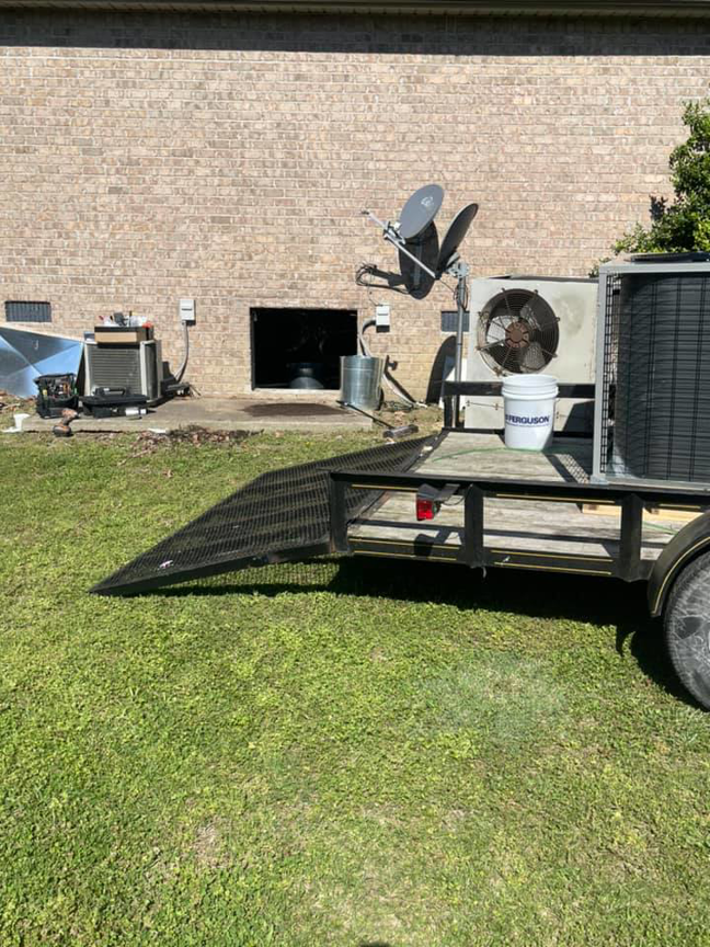 HVAC unit installation in progress with equipment on a trailer and a unit on the ground by Wright Air Care in Murfreesboro, TN.
